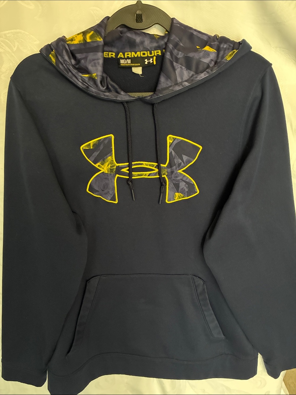 Men’s Under Armour hoodie with blue and gold design.